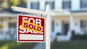 A sold sign outside a large home and a title that reads Selling your home